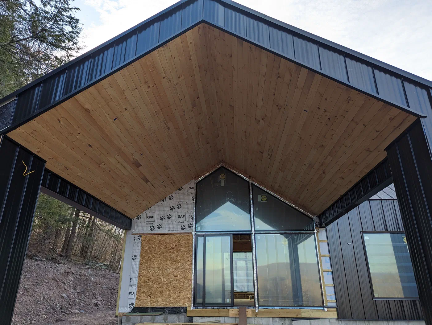 Wood-lined soffit under the deep overhang