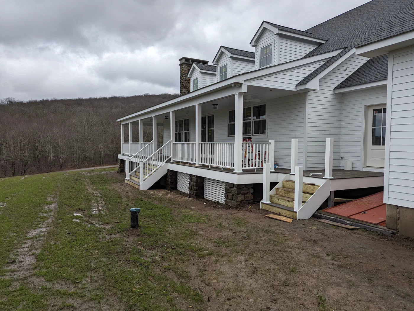 The porch from the side, set on stone piers