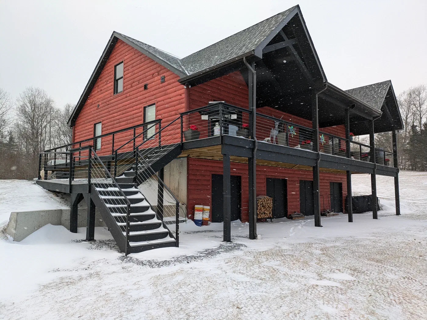 Red board siding with a covered two-level deck