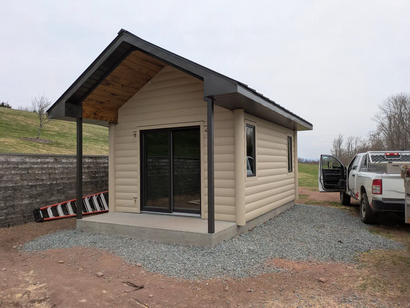 Small outbuilding with a wood-lined porch roof