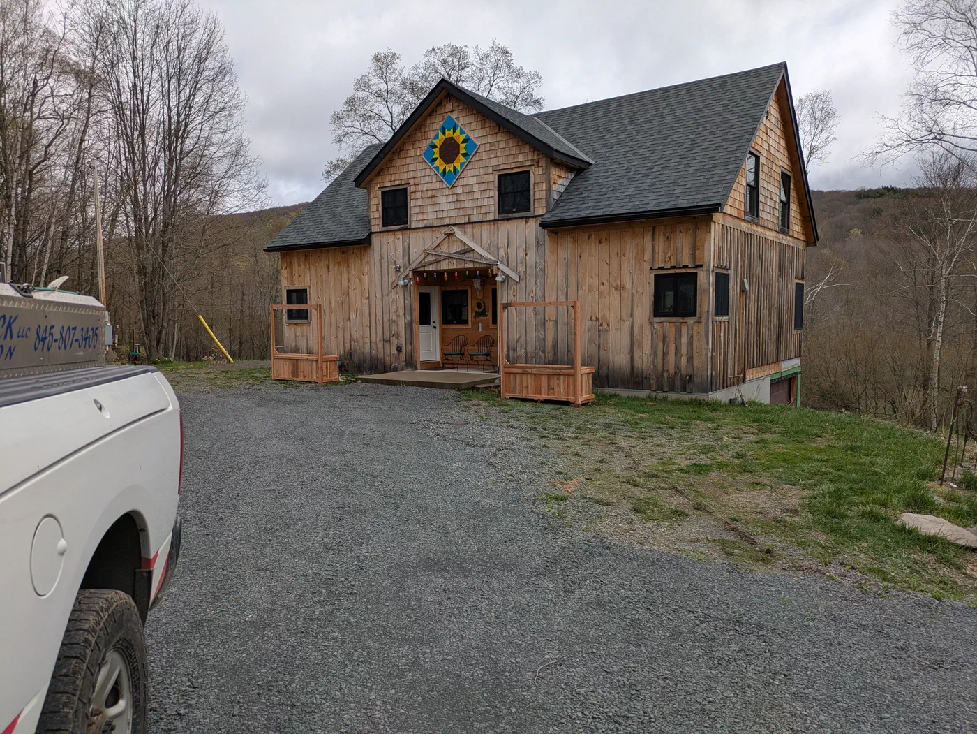 Shingled gable and rough-sawn board siding