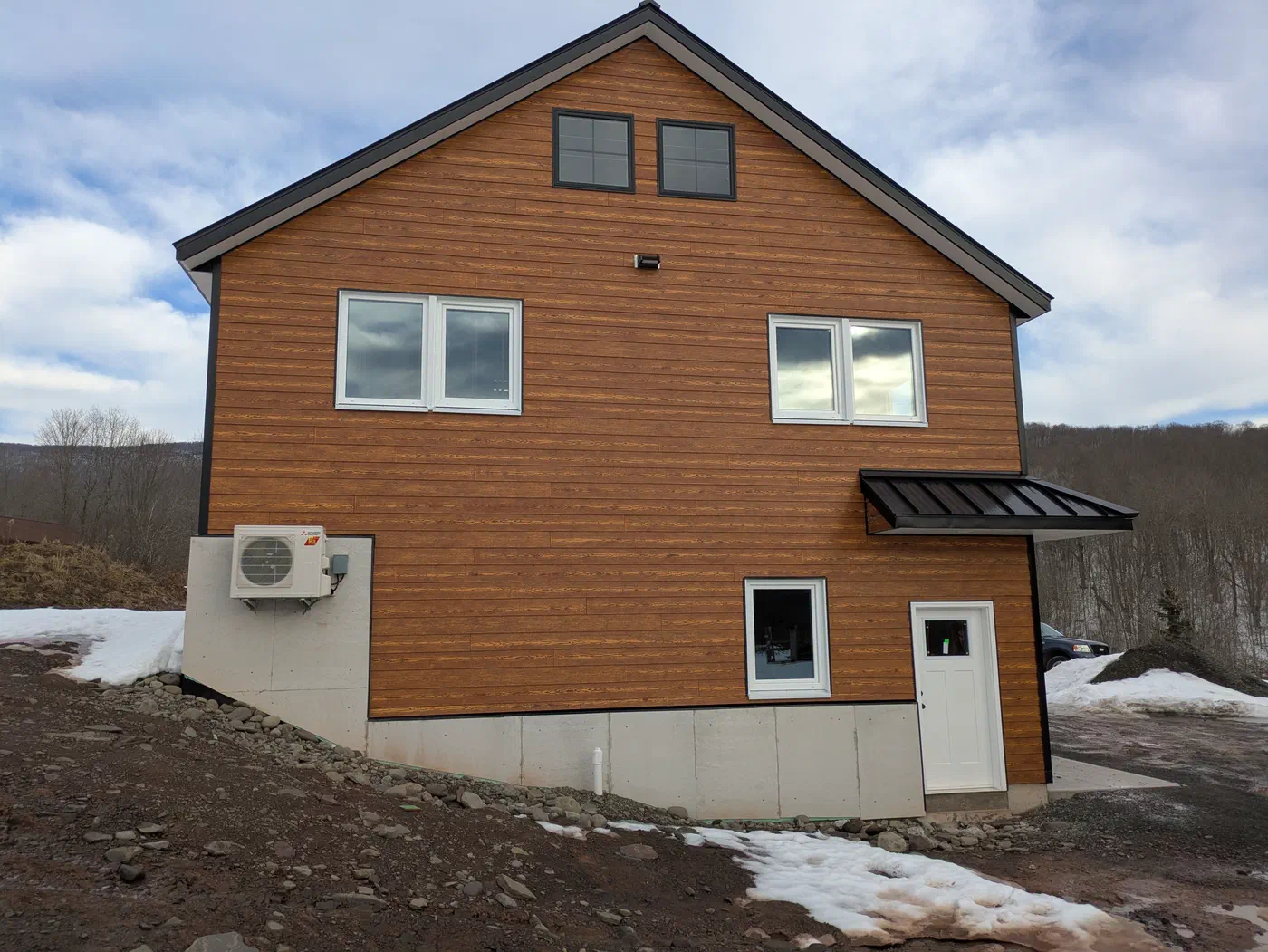 Gable end with a metal awning over the entry